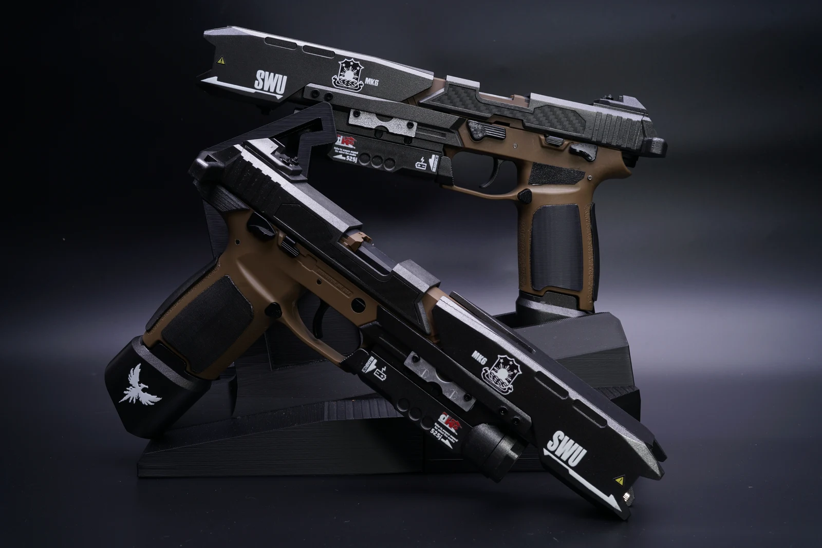 Hand-finished Titanfall smart pistol replicas on display stands